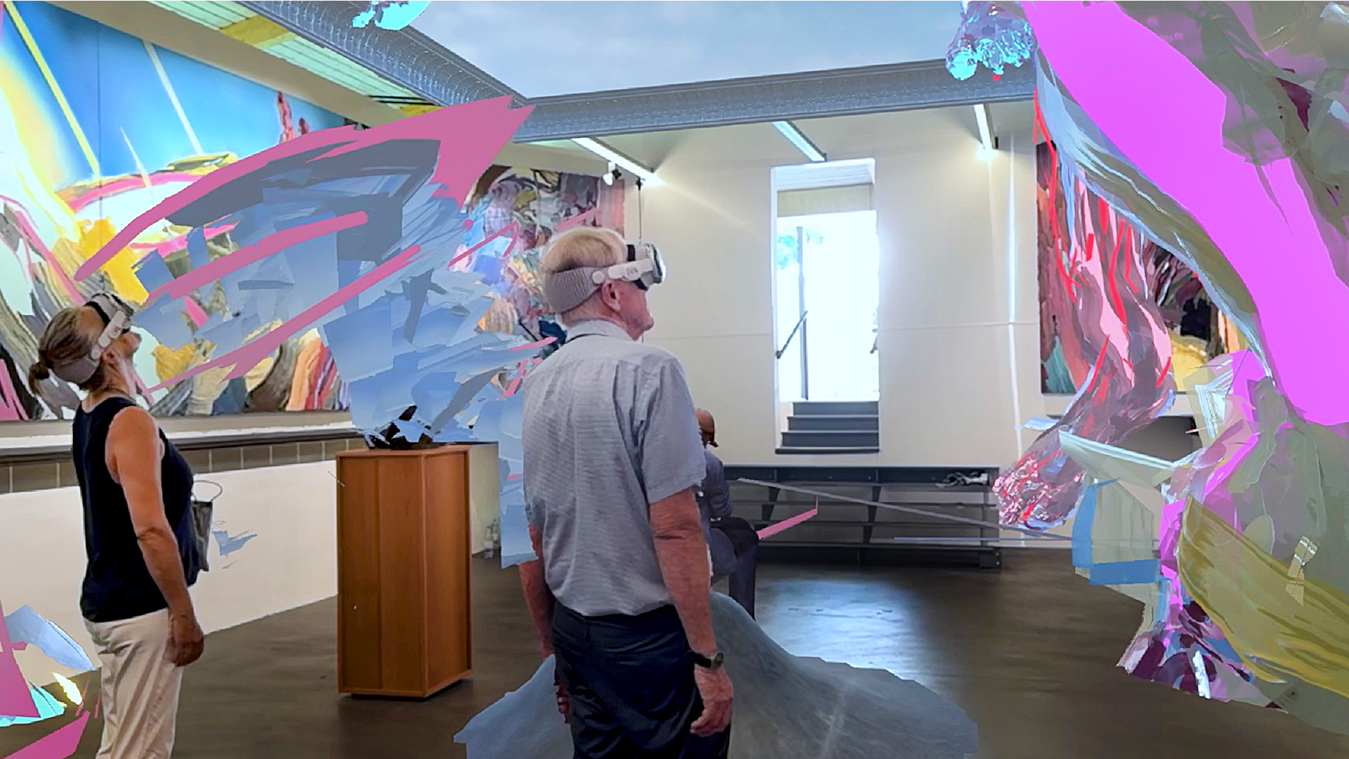 Two visitors in Apple Vision Pro amid the erupting pantheon.
