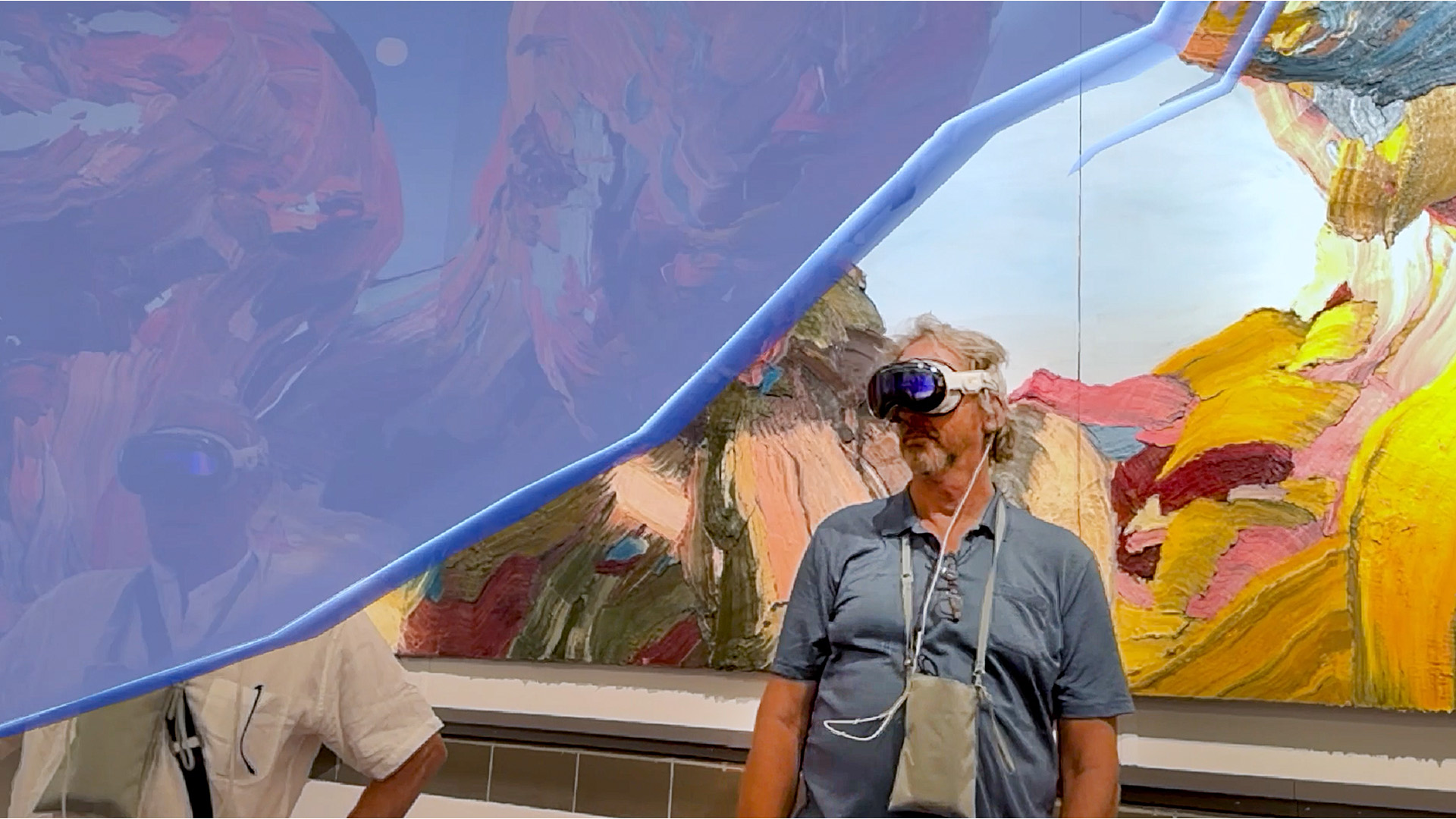 A single visitor immersed in the mixed-reality frieze.